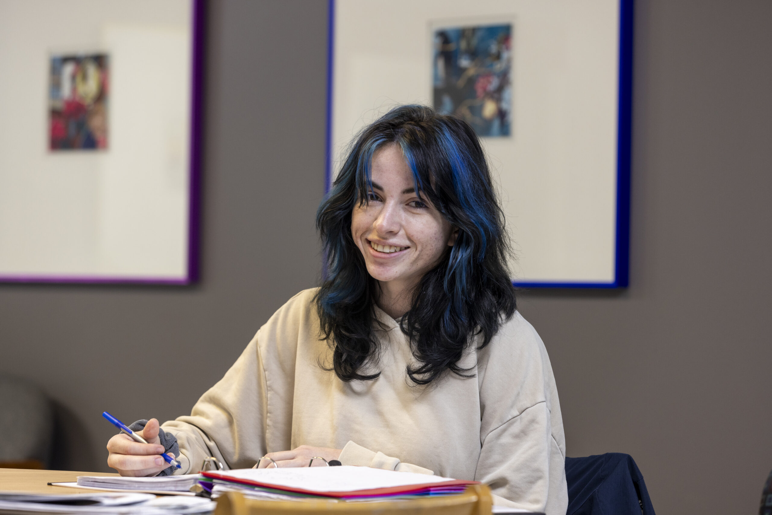 student smiling at camera in classroom