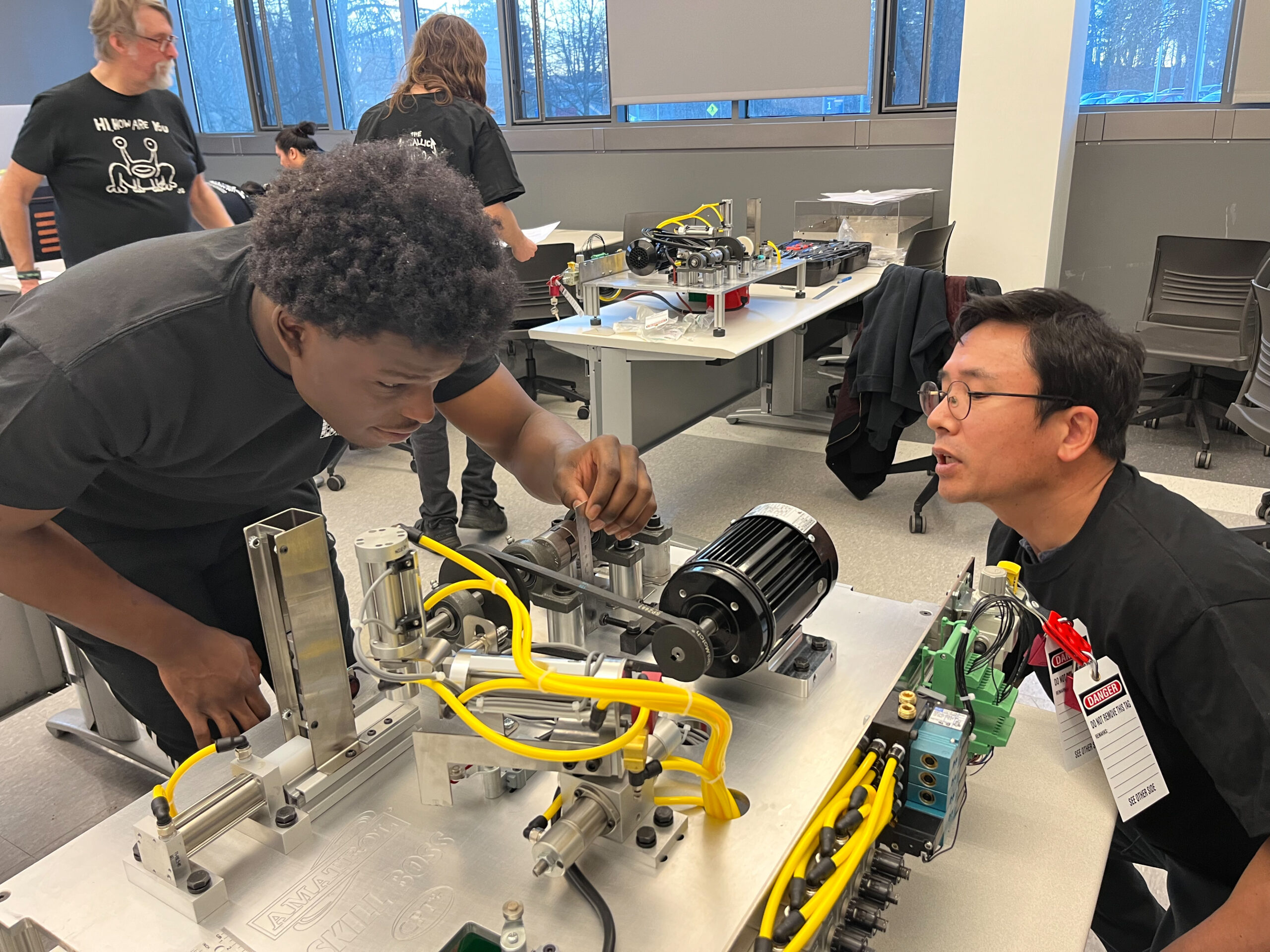 a few students tinkering with electronics