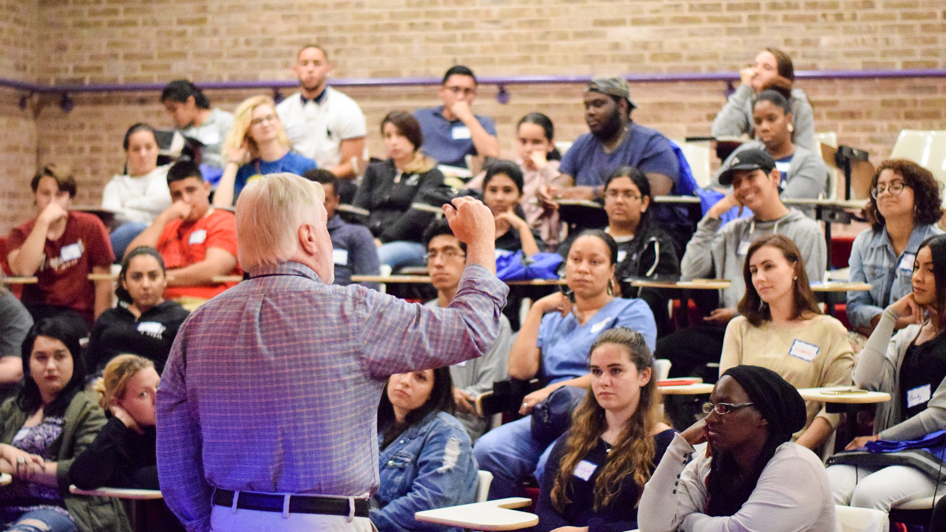 Professor speaking to a student audience in a lecture hall