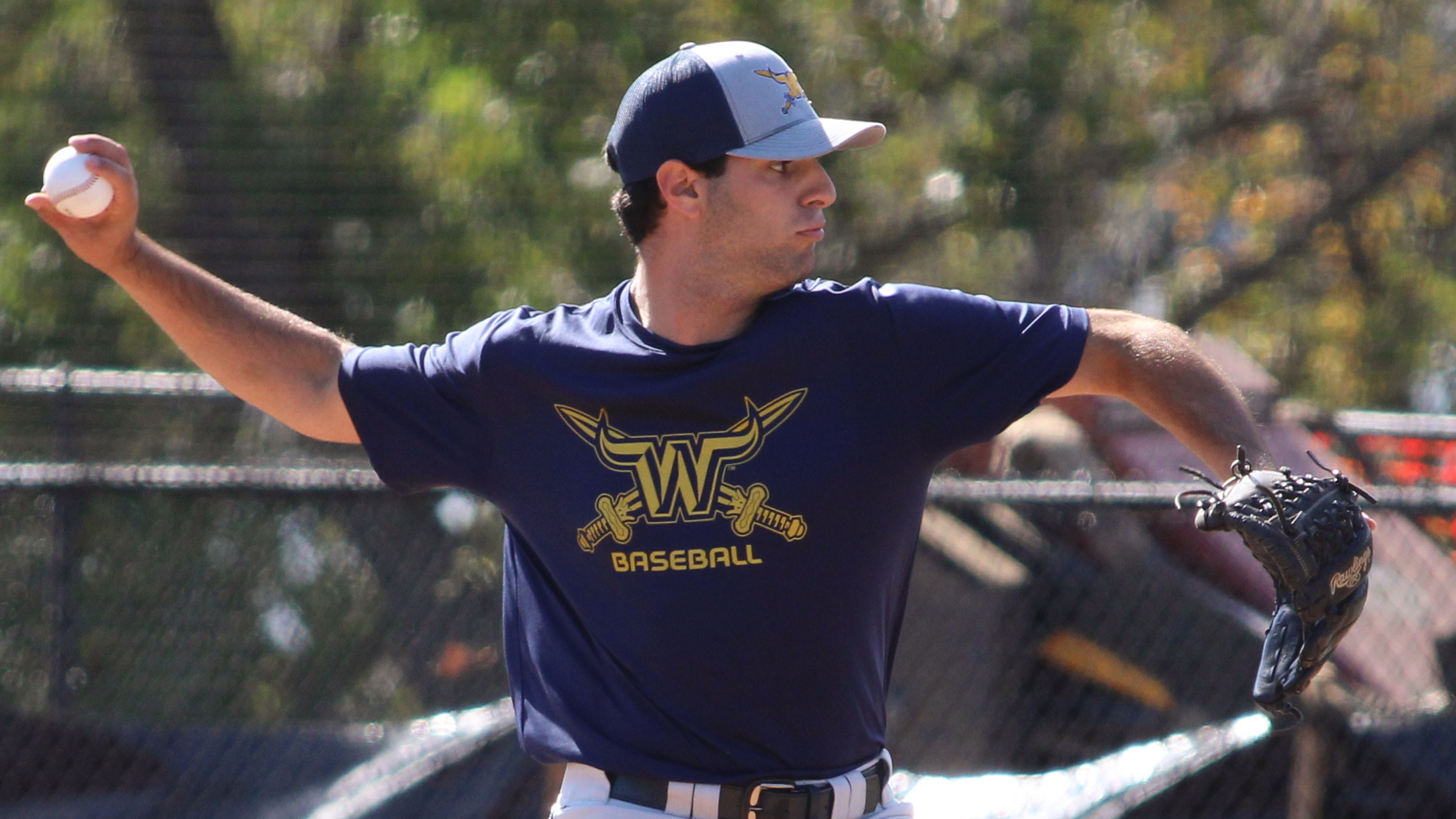 Viking Baseball player throwing a pitch, focus on athletics logo