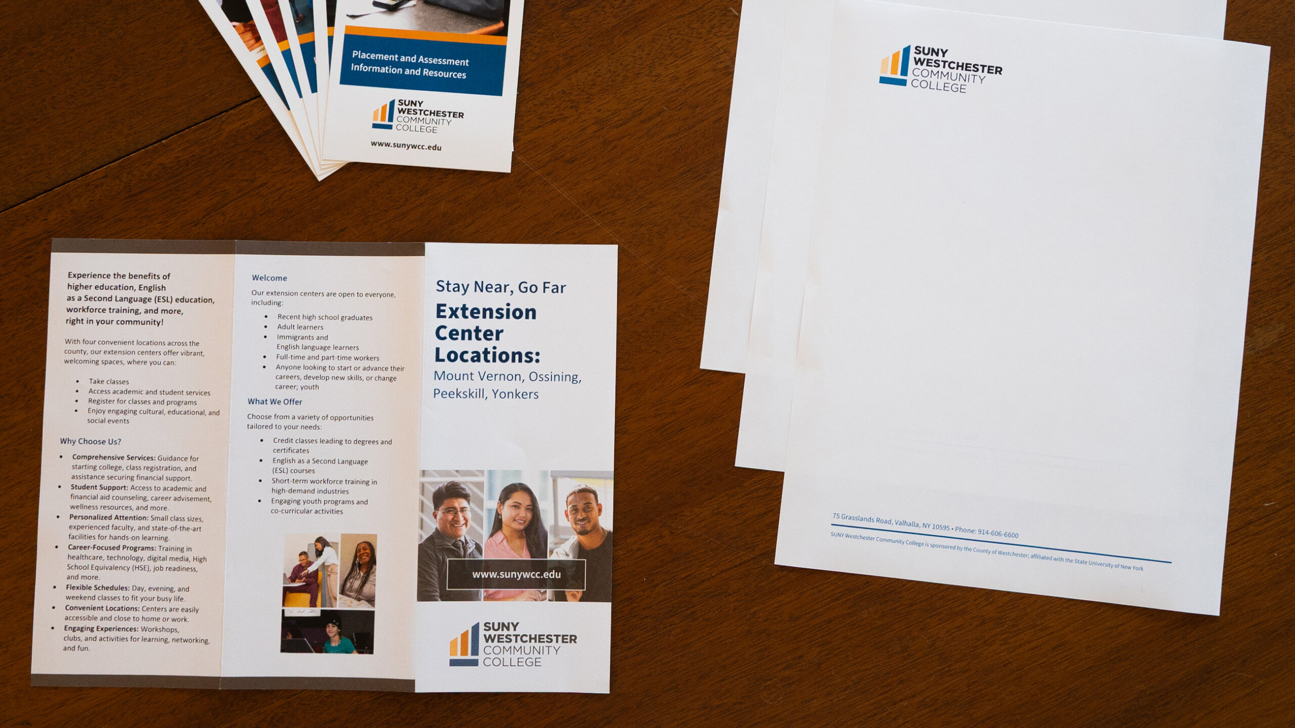 Printed letterhead and brochure template samples on a table